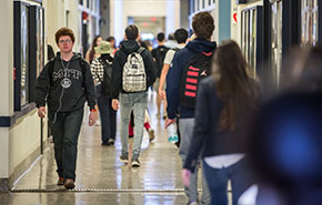 Students walking in a hallway. 